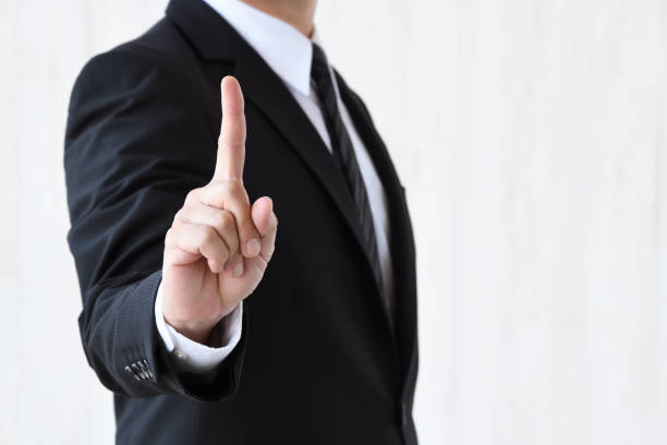 Business man putting up index finger